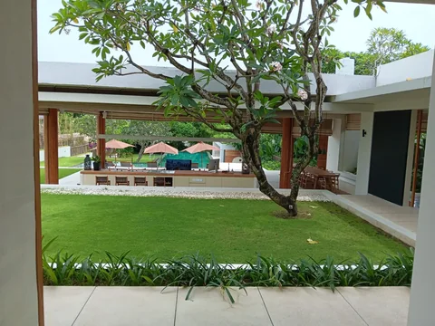Villa garden courtyard framed by open living spaces